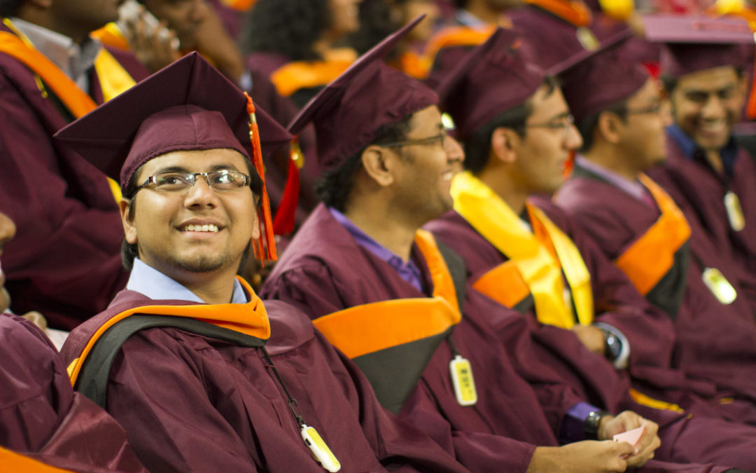A graduate looks up and smiles as he awaits the convocation ceremony to begin
