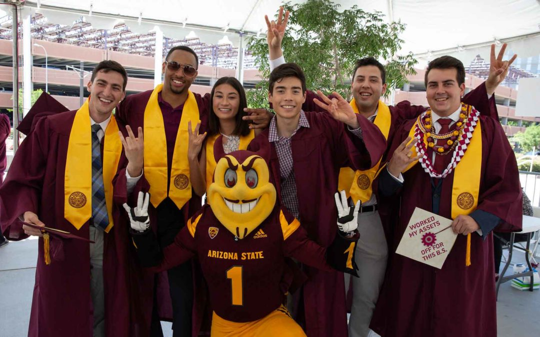 Fulton Schools graduates gather outside Wells Fargo Arena at convocation checkin and pose with Sparky