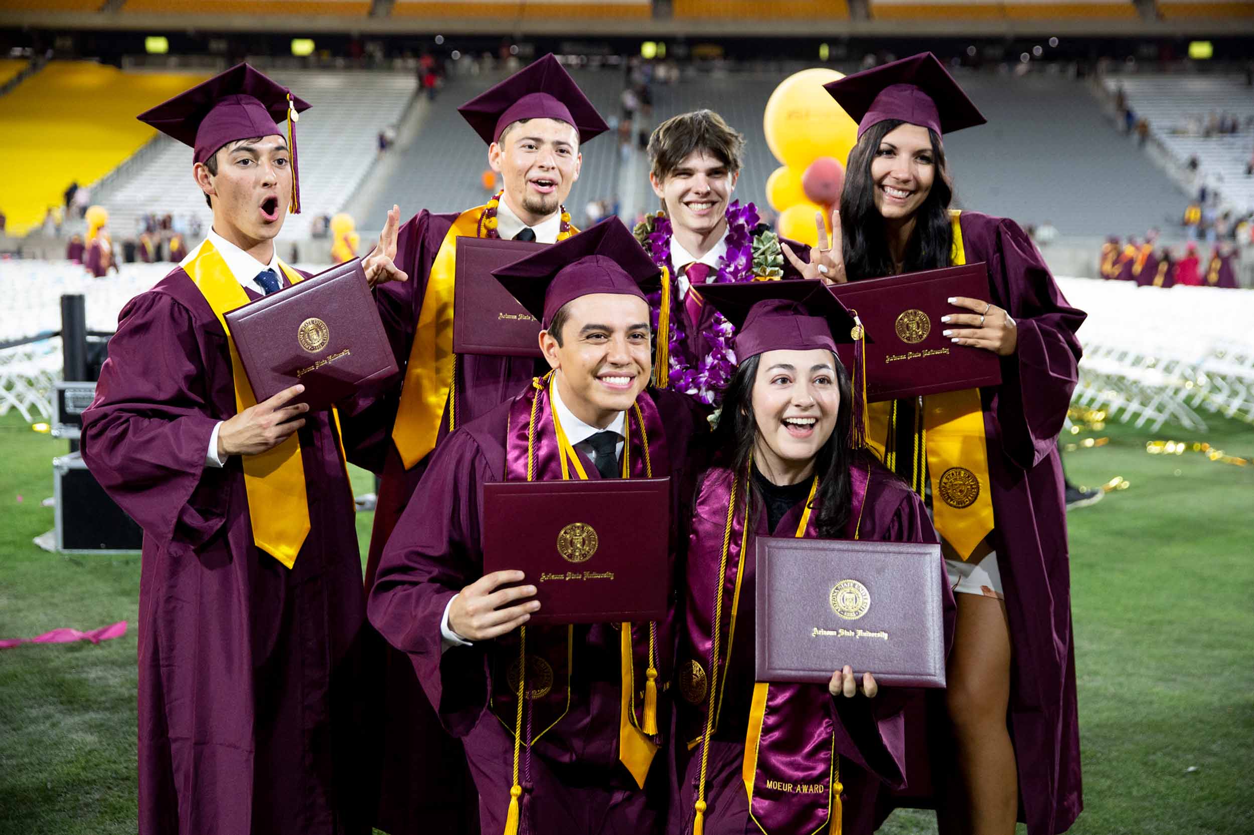 A group of ASU graduates stand together for a photo at Convocation