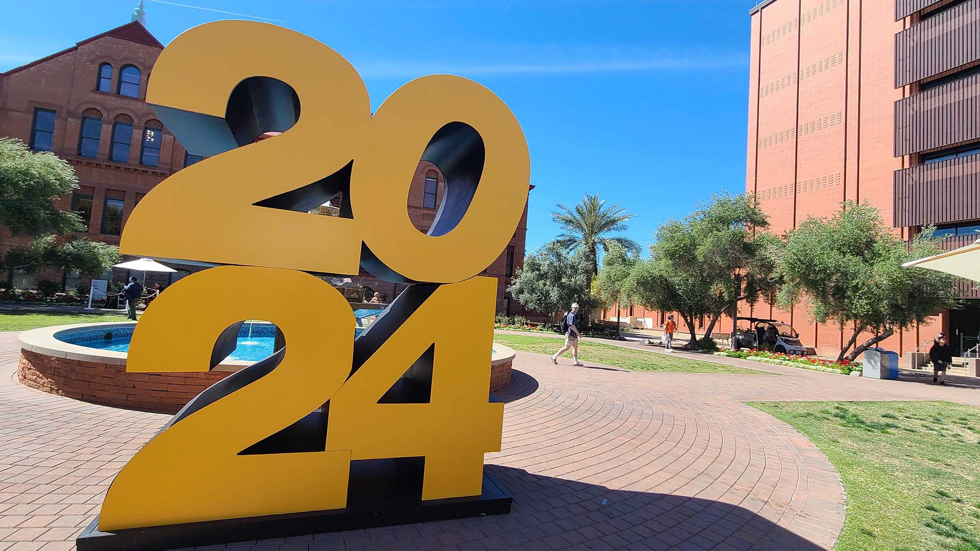 A large, gold "2024" statue sits in front of ASU's Old Main building on the Tempe campus in celebration of the ASU class of 2024.