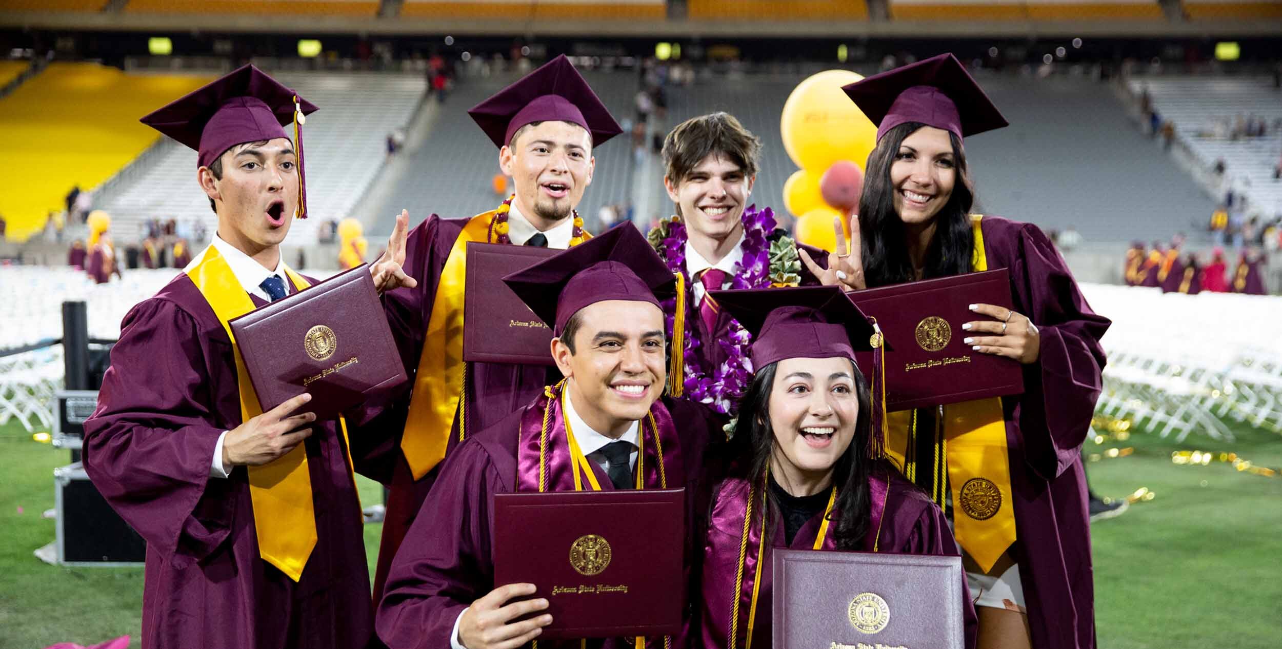 A group of ASU graduates stand together for a photo at Convocation