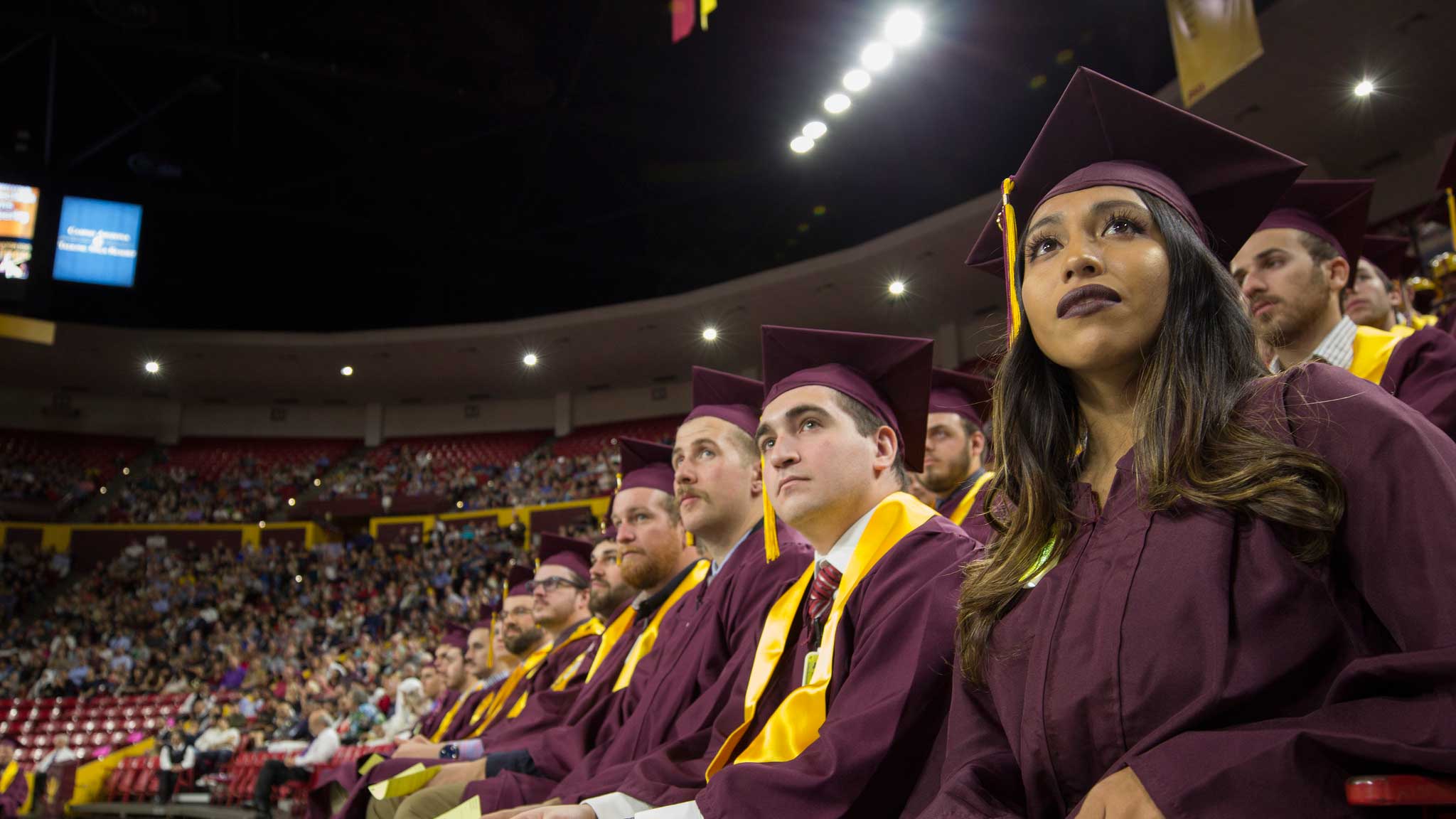 A row of graduates watch the Fulton Schools Convocation attentively