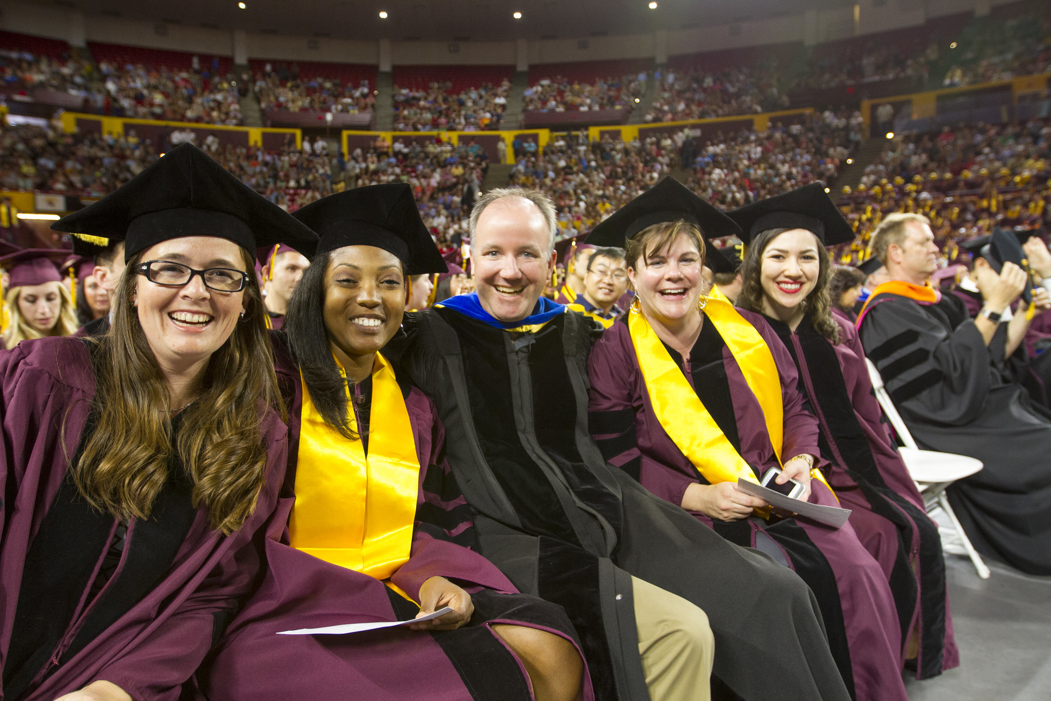 Paul Westerhoff and four students pose together for a photo while participating in the convocation cermony